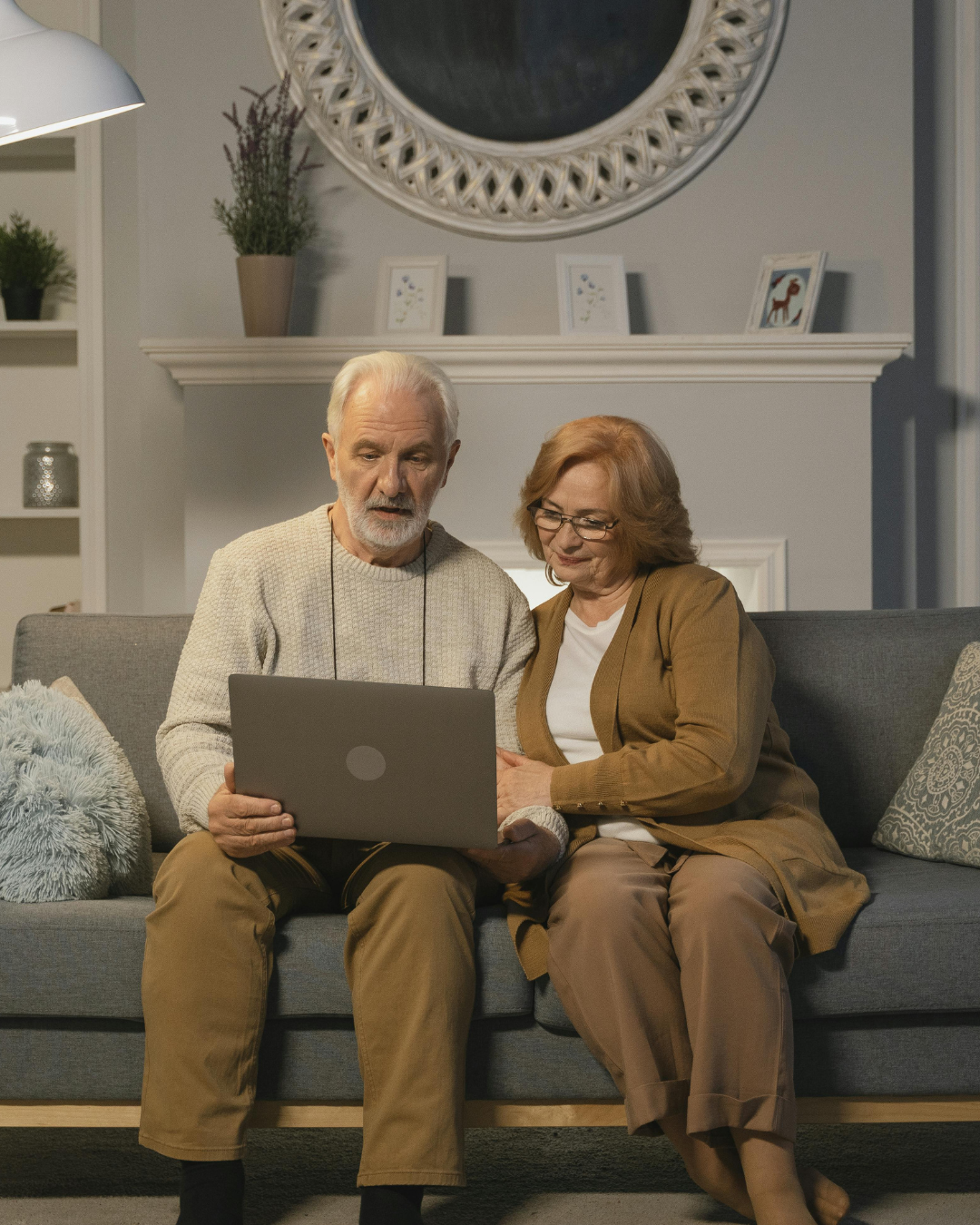 An older couple looking at a laptop together at home